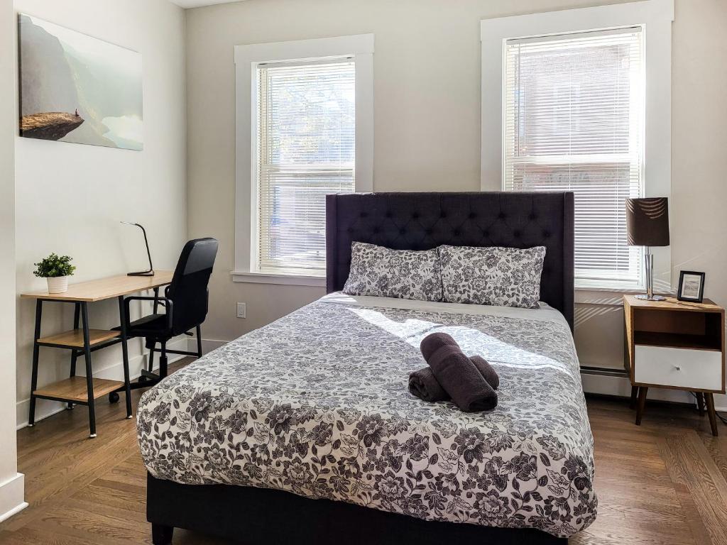 a teddy bear laying on a bed in a bedroom at Beautiful Wooster Sq. getaway - great neighborhood in New Haven