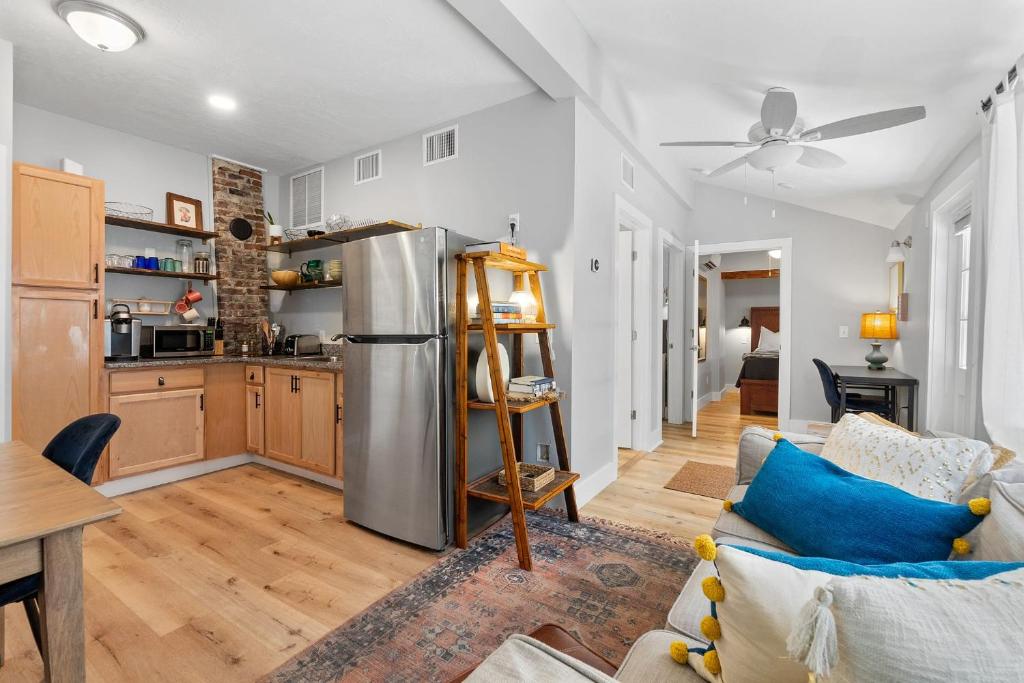 a kitchen and living room with a stainless steel refrigerator at Courtyard Flat - City Center Walk to Everything in Saint Augustine