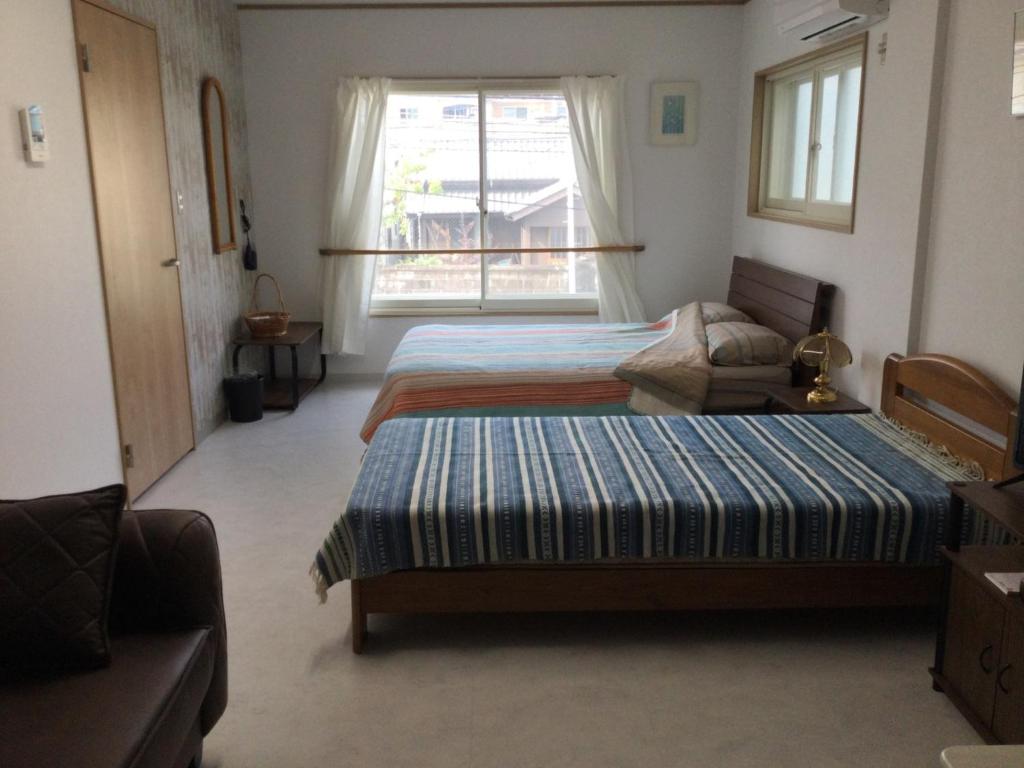宮崎市にあるAccommodation Service - Vacation STAY 43779vのベッドルーム1室(ベッド2台、窓付)