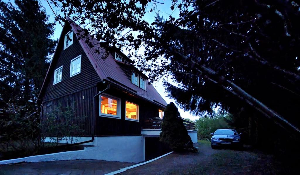 a house with a car parked in front of it at Dom Letniskowy, Siła in Sila
