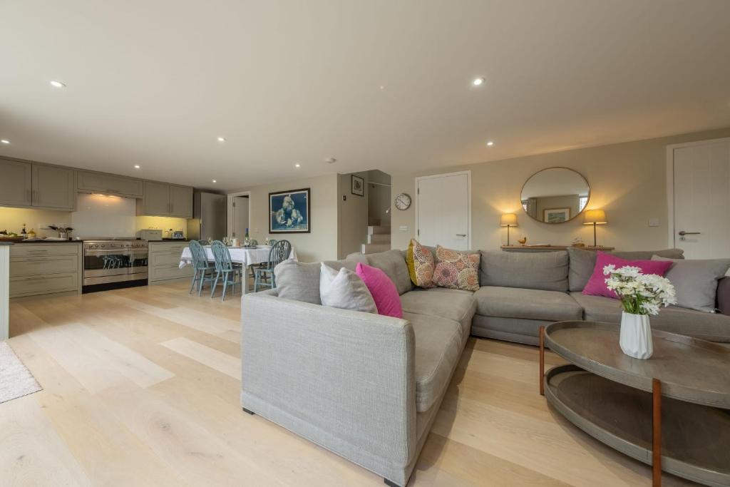 a living room with a couch and a table at 1 Railway Cottages H in Holt