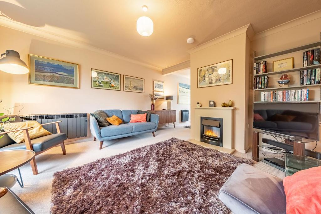 a living room filled with furniture and a fireplace at 12 The Close in Brancaster