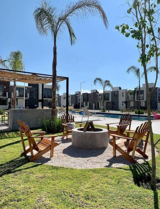 a park with benches and a fountain and a palm tree at Básico Departamento in Puebla