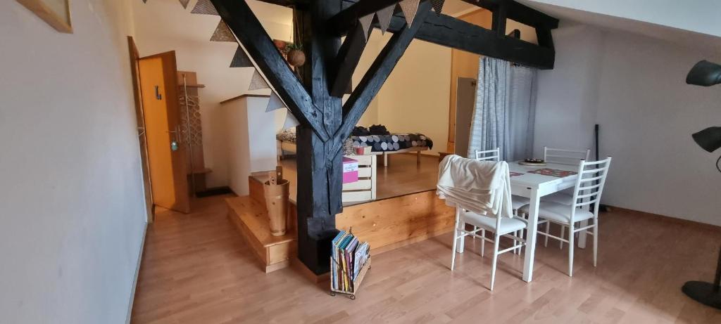 a kitchen and dining room with a table and chairs at Chambre d'Hôtes R&S in Bemont