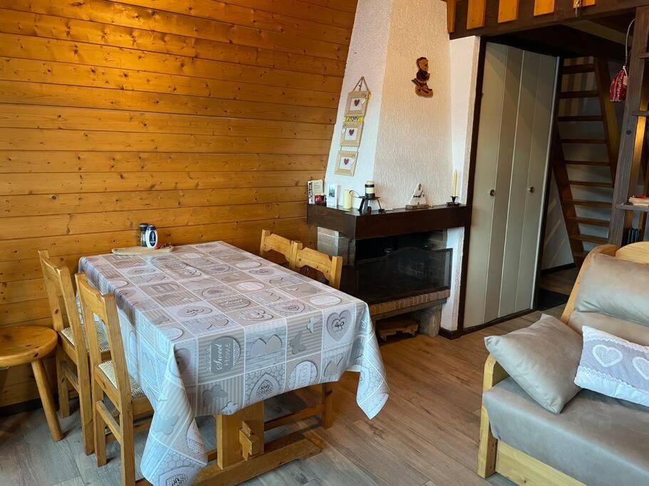 a dining room with a table and a chair at Duplex sur Morzine avec vue imprenable in Morzine