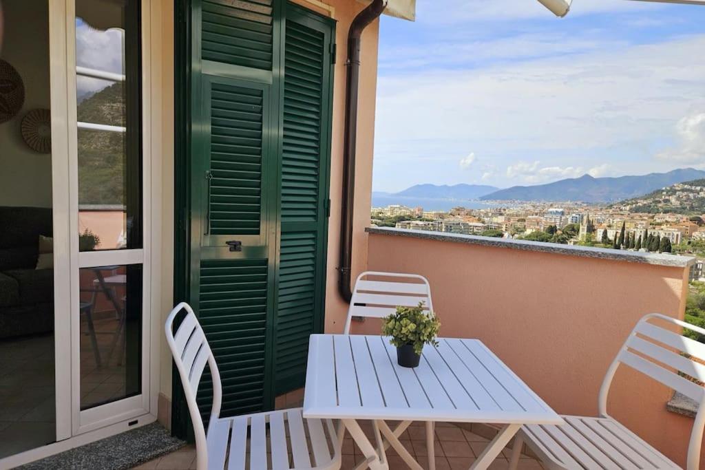 una mesa y sillas en un balcón con vistas en Borgio Verezzi appartamento con parcheggio, en Borgio Verezzi