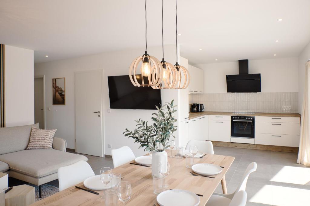 a kitchen and living room with a table and chairs at SKAN-PARK Ferienhäuser & Tiny Houses am Bärwalder See in Jahmen Ausbau