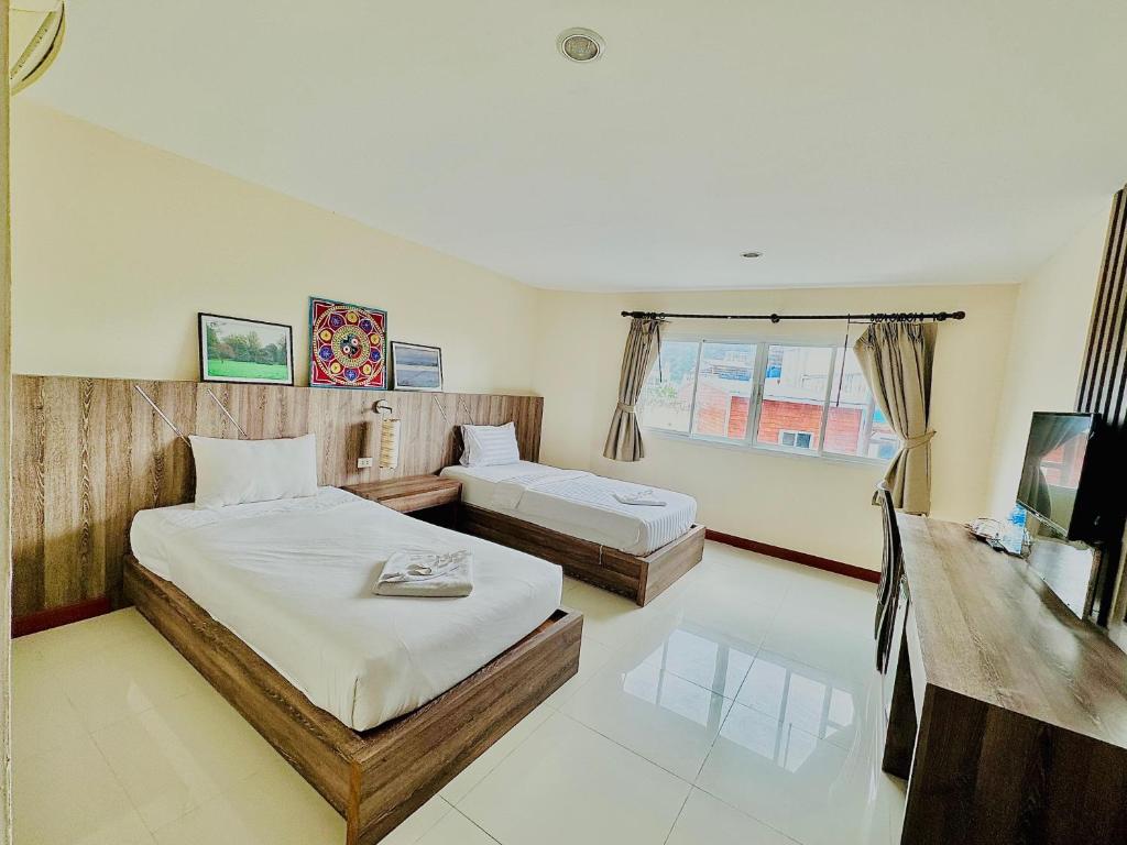 Postel nebo postele na pokoji v ubytování Cocoon Patong Hotel