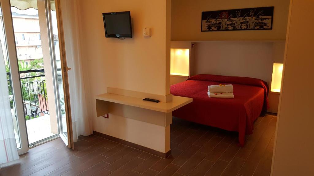 Łóżko lub łóżka w pokoju w obiekcie Hotel Perla Verde