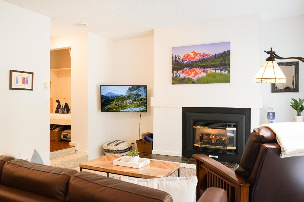 a living room with a couch and a fireplace at Mt Baker Den, Sleeps 4 in Glacier