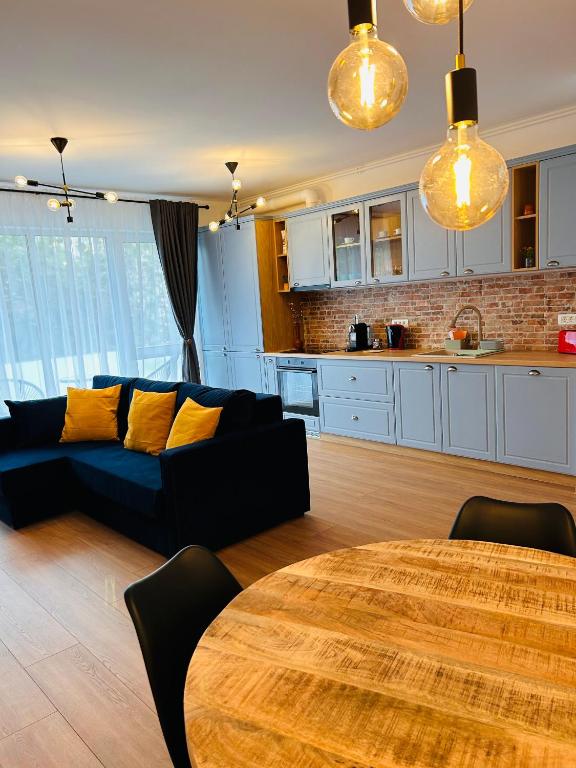 a living room with a couch and a table at Brand new, feel at home residence in Timişoara