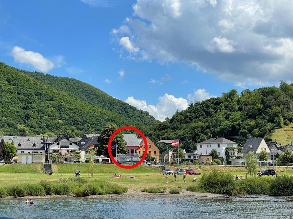 a red circle in a field next to a river at Ferienwohnung Aroma Moselblick in Burgen