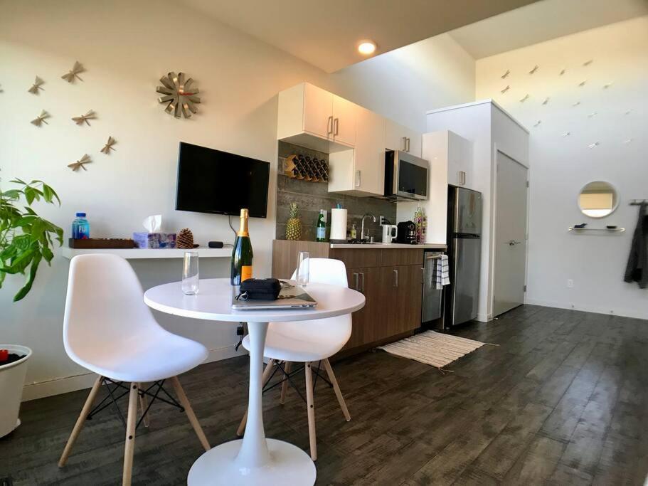 a living room with a white table and white chairs at Modern Capitol Hill Studio Steps to Volunteer Park in Seattle