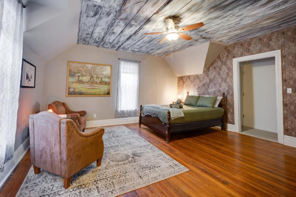 a living room with a ceiling fan and a couch at Historic Condo 2,5 Blocks From Fm Bank Arena in Clarksville