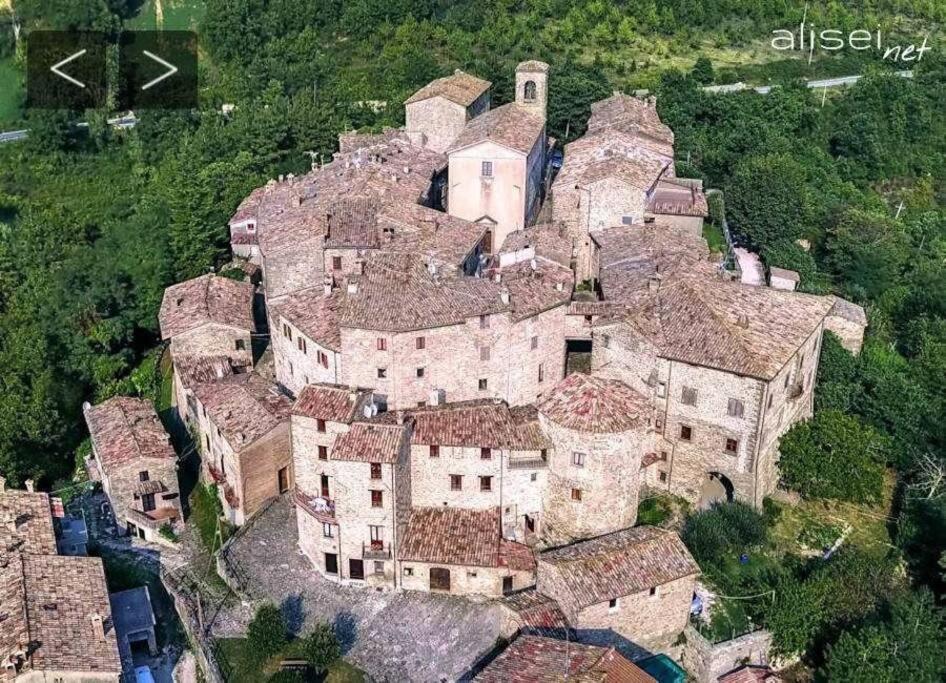 an aerial view of a large house with roofs at Casa in Borgo Medievale in Toscana in Monterone