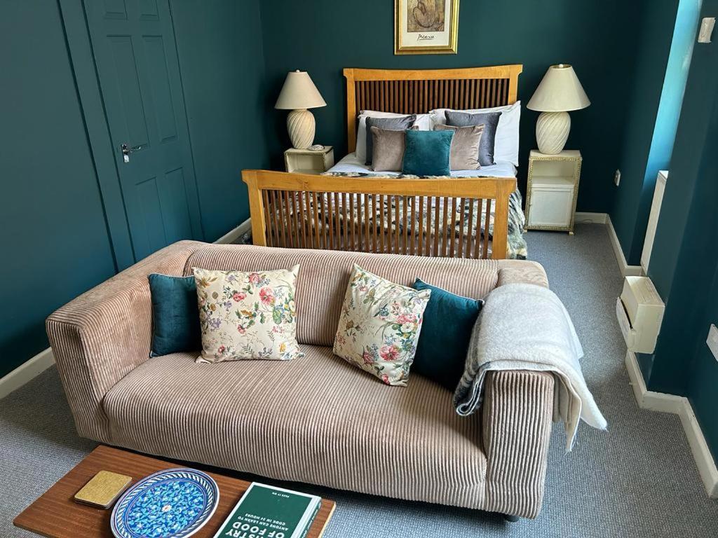 a living room with a couch and a bed at John Street Apartment 3 in Bristol