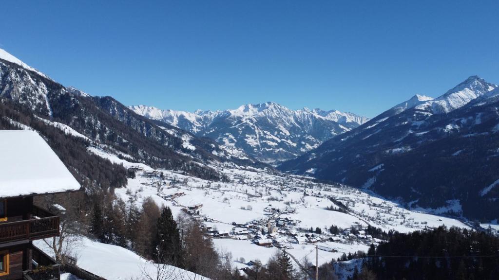 a view of a snow covered valley with mountains at Budamerhof in Virgen