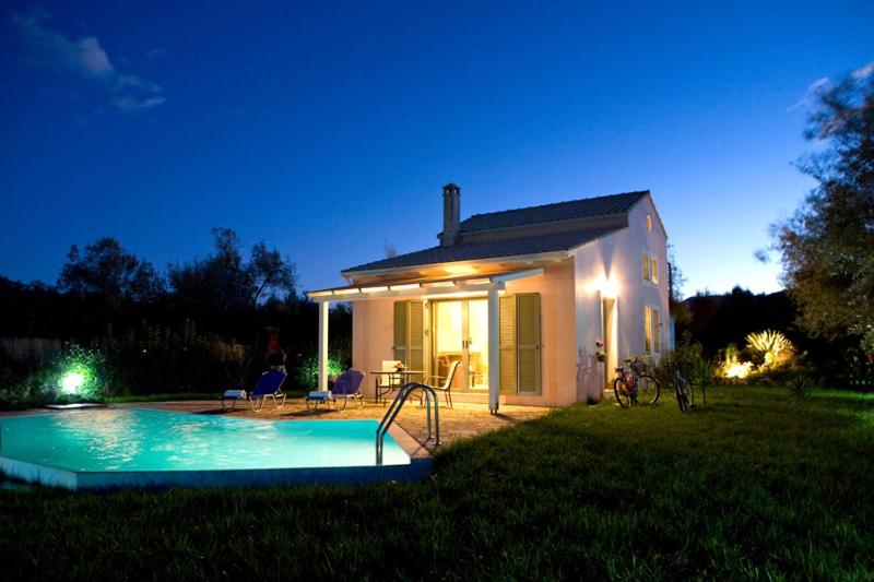 a small house with a swimming pool in the yard at Villa Fotini in Lefkada Town