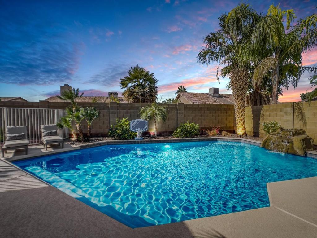 a swimming pool in a yard with palm trees at Chandler Earhart in Chandler