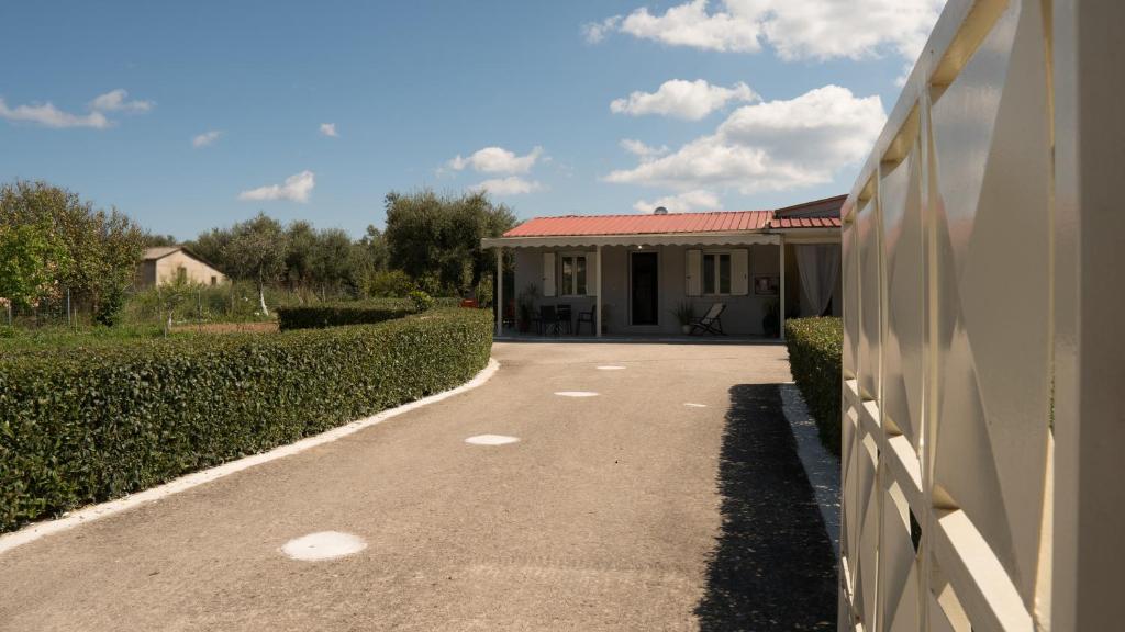 a driveway leading to a house with a building at Nafsika House in Áyios Kírikos