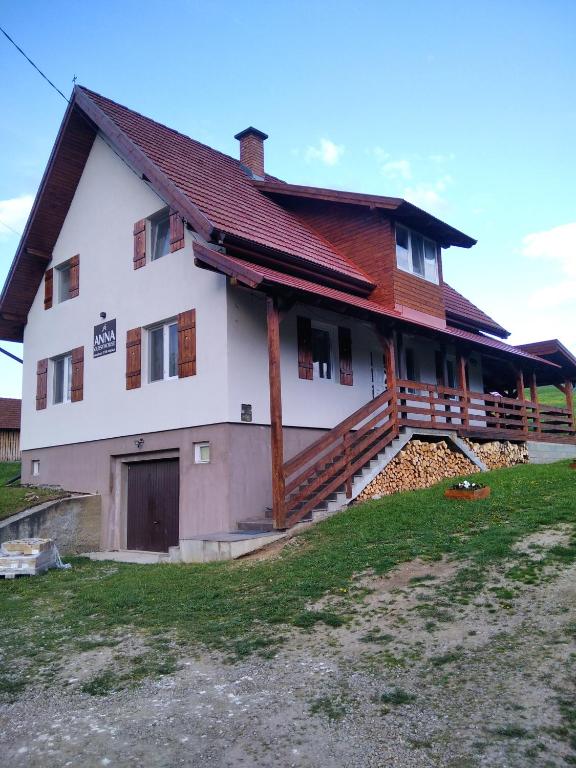a large house with a gambrel roof at Anna Guesthouse in Lunca de Sus