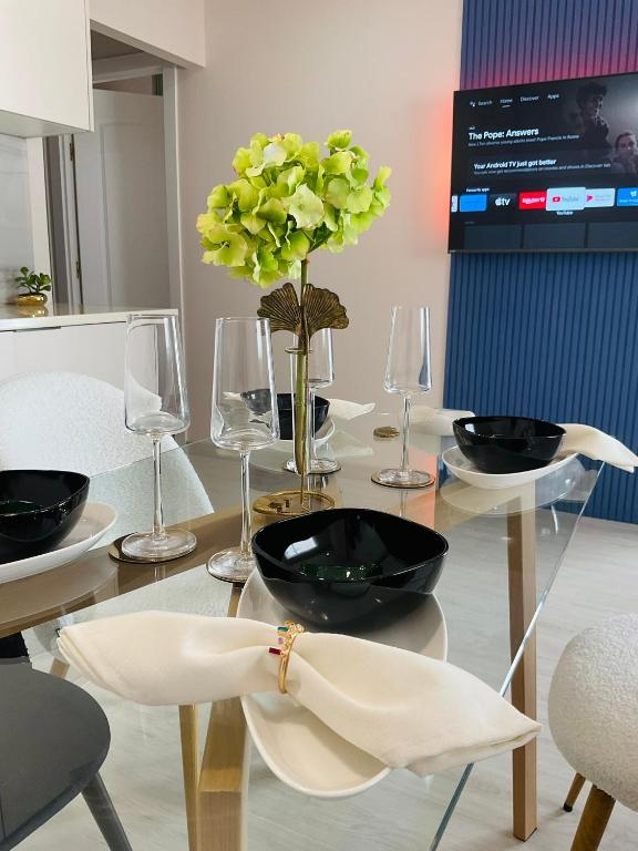 a glass table with a vase with a flower on it at Palangre Luxury Apartment in Torrevieja