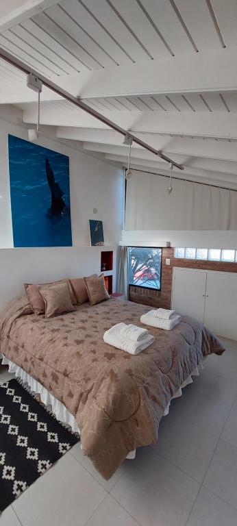 a large bedroom with a large bed in a room at Las Anémonas Sur in Puerto Madryn