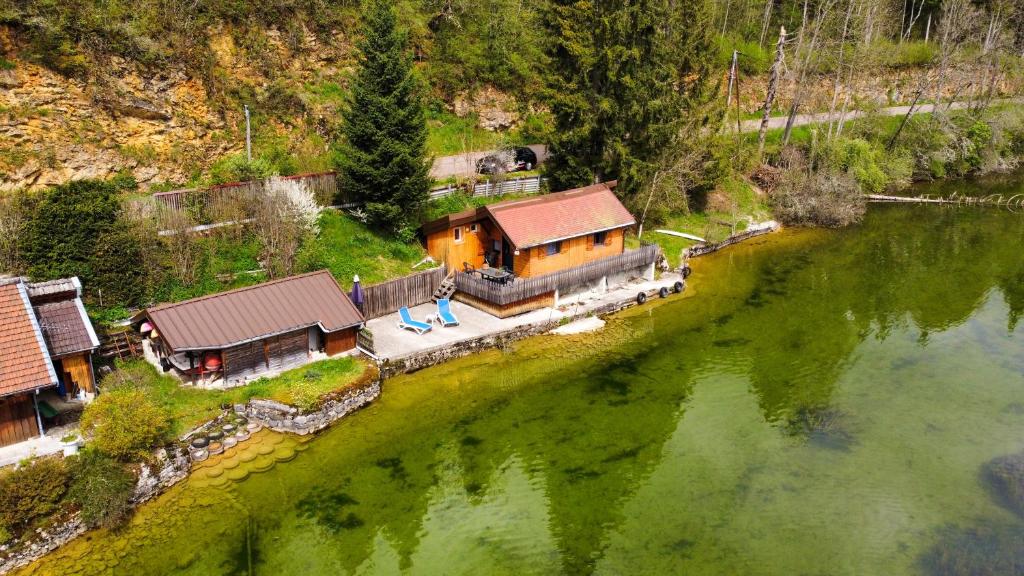 an aerial view of a house next to a river at Le Havre du Lac St Point in Saint-Point-Lac