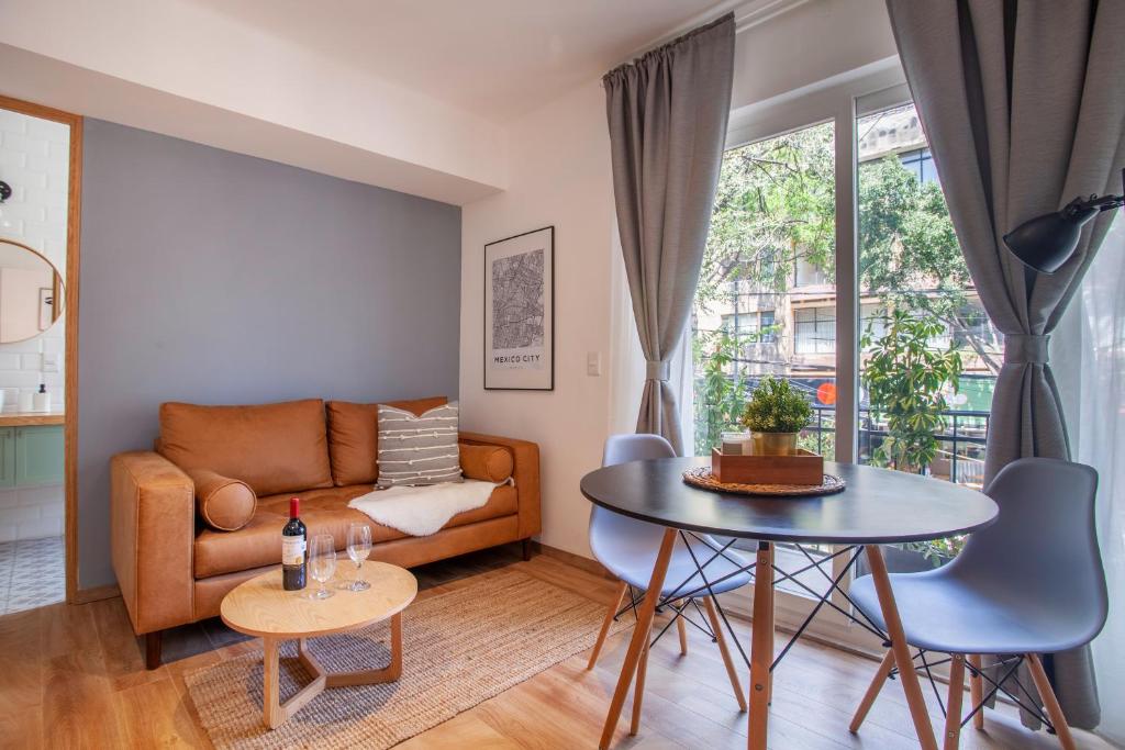 a living room with a couch and a table at Bright & sweet unit in the heart of Polanco. in Mexico City