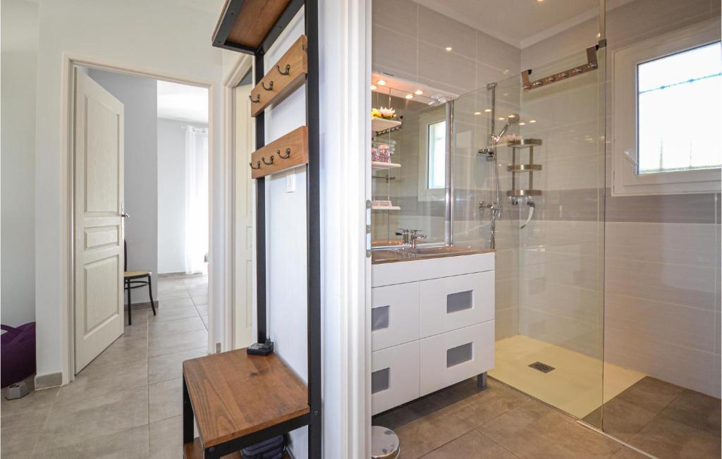 a bathroom with a sink and a glass shower at 2 Bedroom Amazing Home In Saint-ambroix in Saint-Ambroix