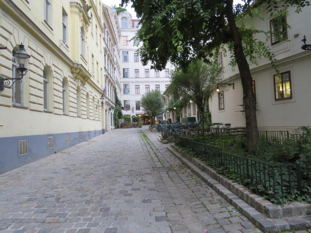 a cobblestone street in a city with buildings at Ferienwohnungen Spittelberg Schrankgasse in Vienna