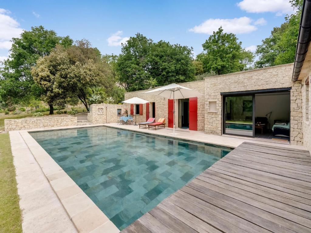 マロセーヌにあるLuxurious Villa in Malaucene with Private Swimming Poolの木製デッキ付きのスイミングプールが隣接しています。