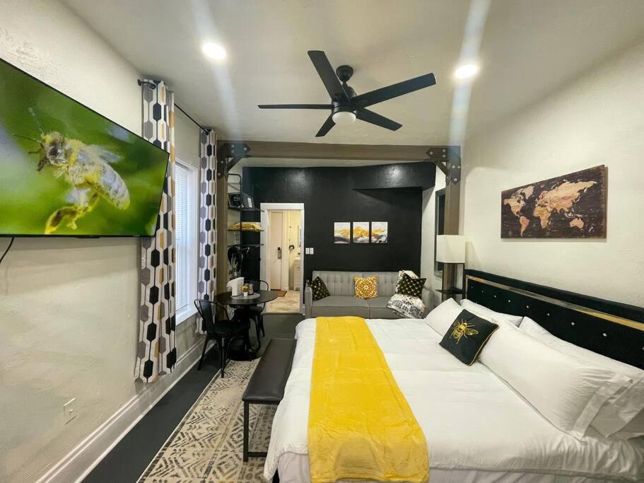 a bedroom with a large bed and a ceiling fan at Bee our Guest! SLC Cozy Beehive in Salt Lake City