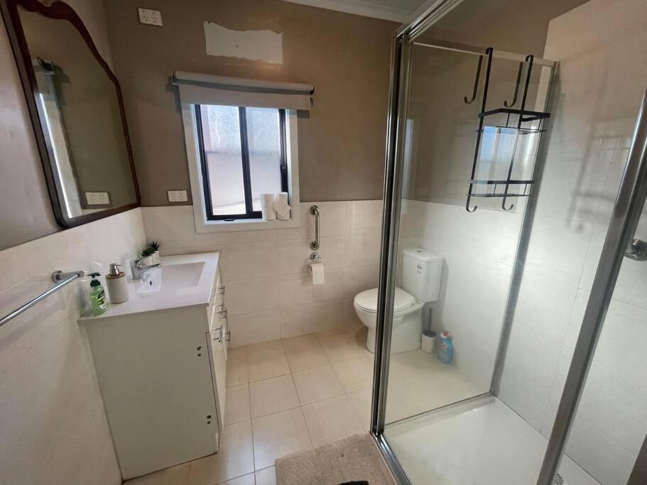 a bathroom with a shower and a toilet at Sandown Springvale close to shop/station in Springvale