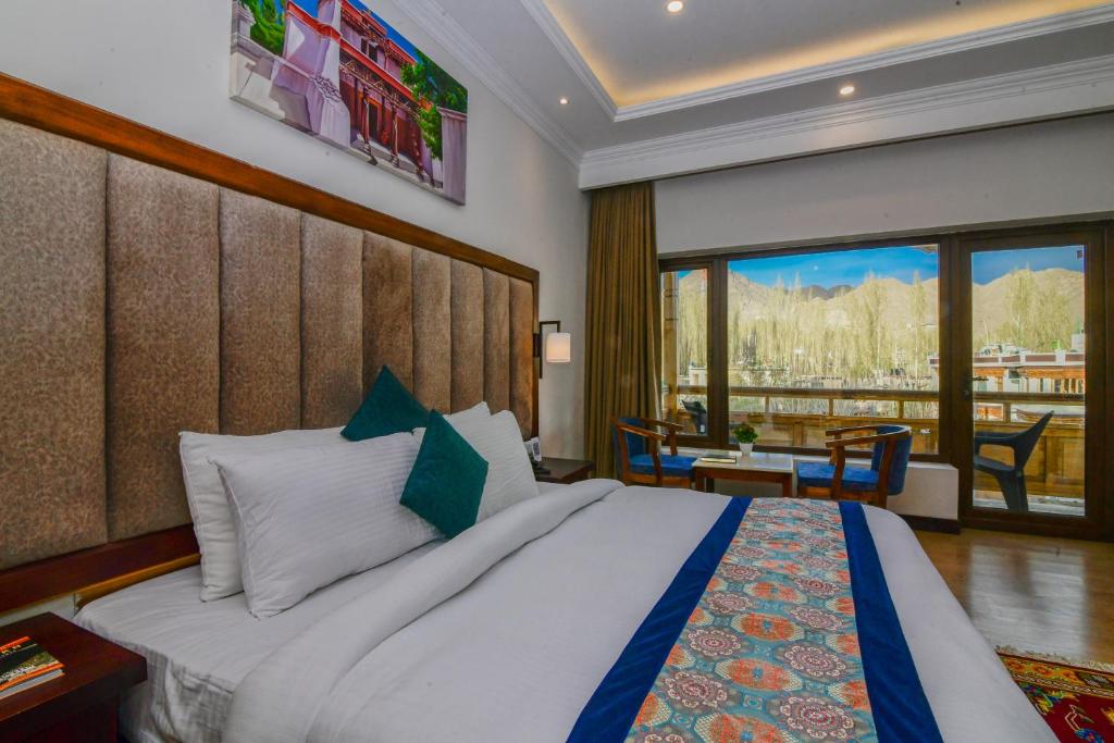Schlafzimmer mit einem großen Bett und Aussicht in der Unterkunft hotel barath ladakh in Leh