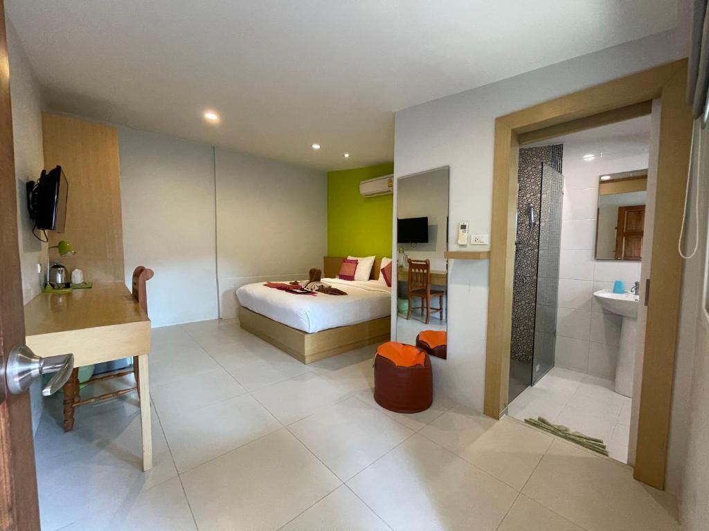 a hotel room with a bed and a bathroom at Good 9 at Home in Rawai Beach