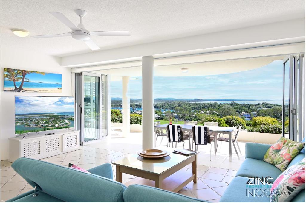 a living room with a couch and a table at Crest Premium View Apartment 19 in Noosa Heads