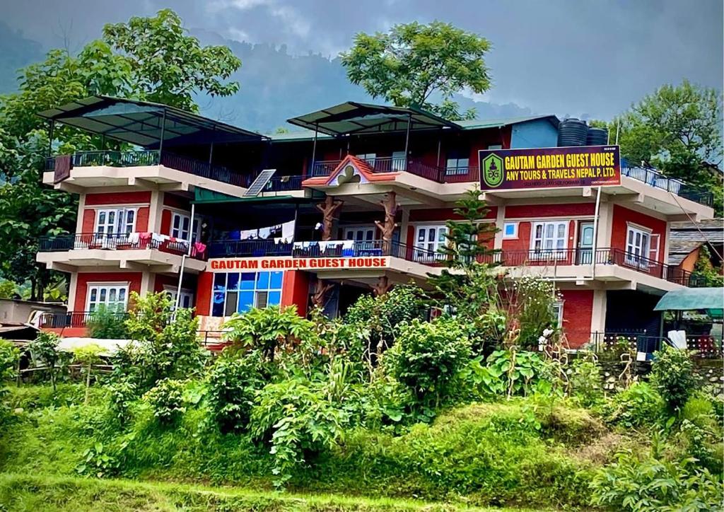 a building with a sign in front of it at GAUTAM GARDEN GUEST HOUSE in Pokhara