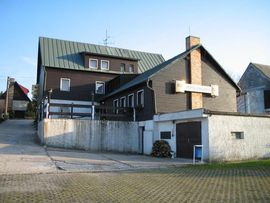 a building with a sign on the side of it at Hotel-Penzion Johanka in Háj