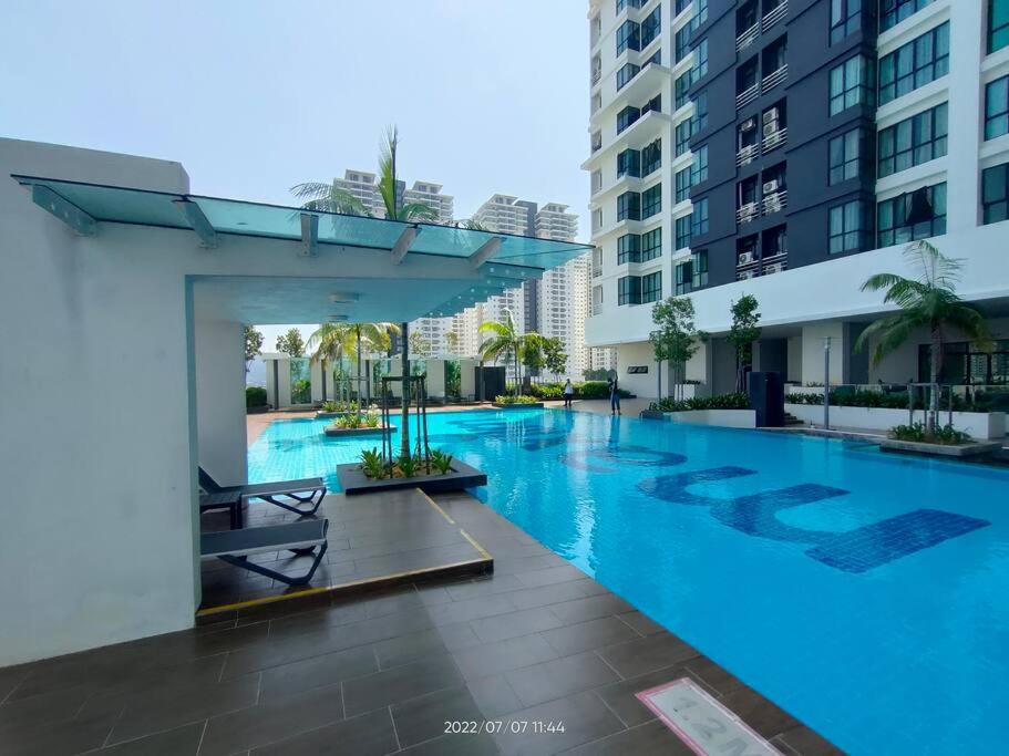a large swimming pool in the middle of a building at Da Best Guesthouse One Maxim Sentul Nice Cozy Condo 3 Rooms Aircond in Sentul KL in Kuala Lumpur