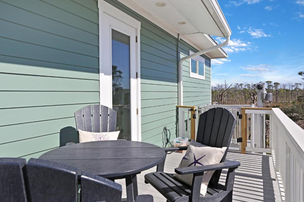 a patio with a table and chairs on a house at Havin A Blas by Pristine Properties Vacation Rentals in Cape San Blas