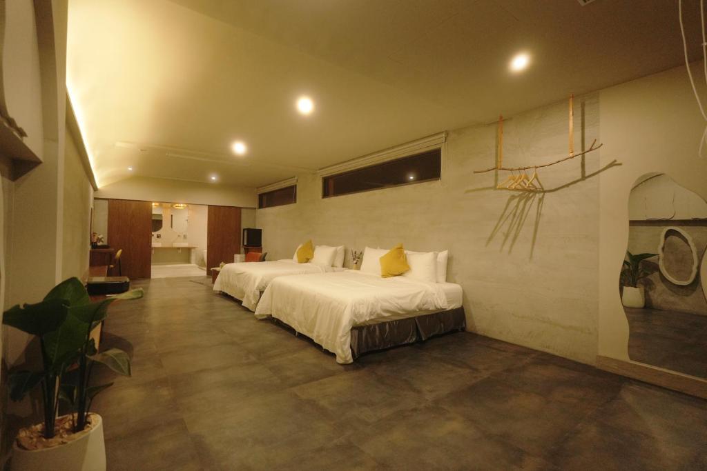 a bedroom with two beds and a basketball painting on the wall at Sun-kissed villa in Hengchun