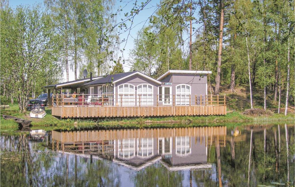 a house on a dock next to a body of water at Amazing Home In Ryssby With 1 Bedrooms, Sauna And Wifi in Hörda