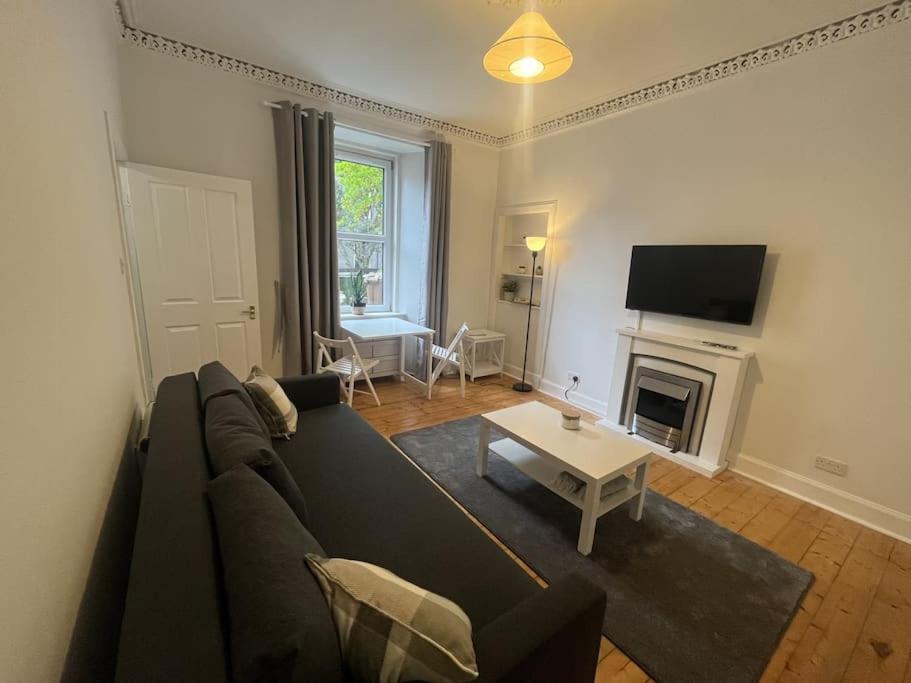 a living room with a couch and a table at The Leith Walk Flat (just off) in Edinburgh