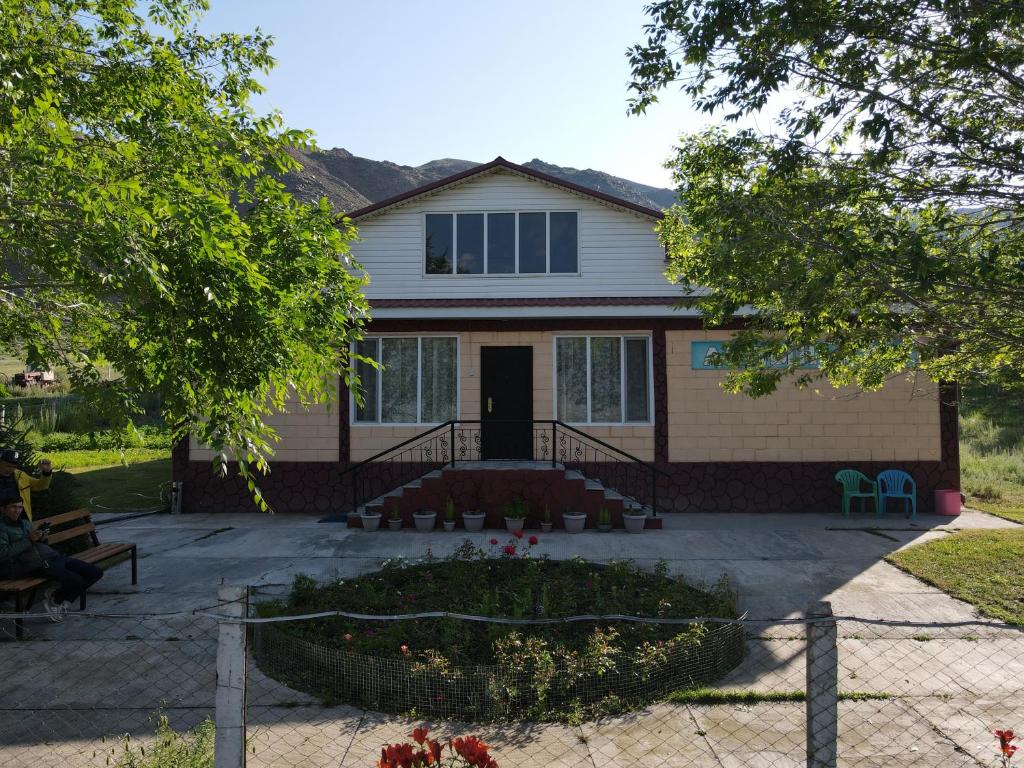a house with a fence in front of it at Guest house Aidyn-Kul in Toguz-Bulak