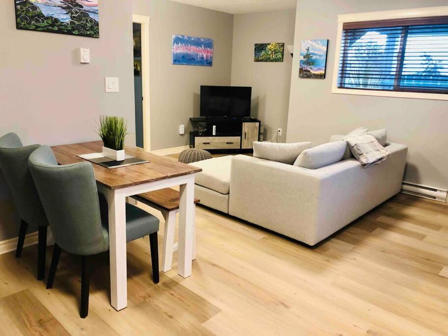 a living room with a couch and a table at Olympic Views - Cozy Modern 2Br Suite in Victoria