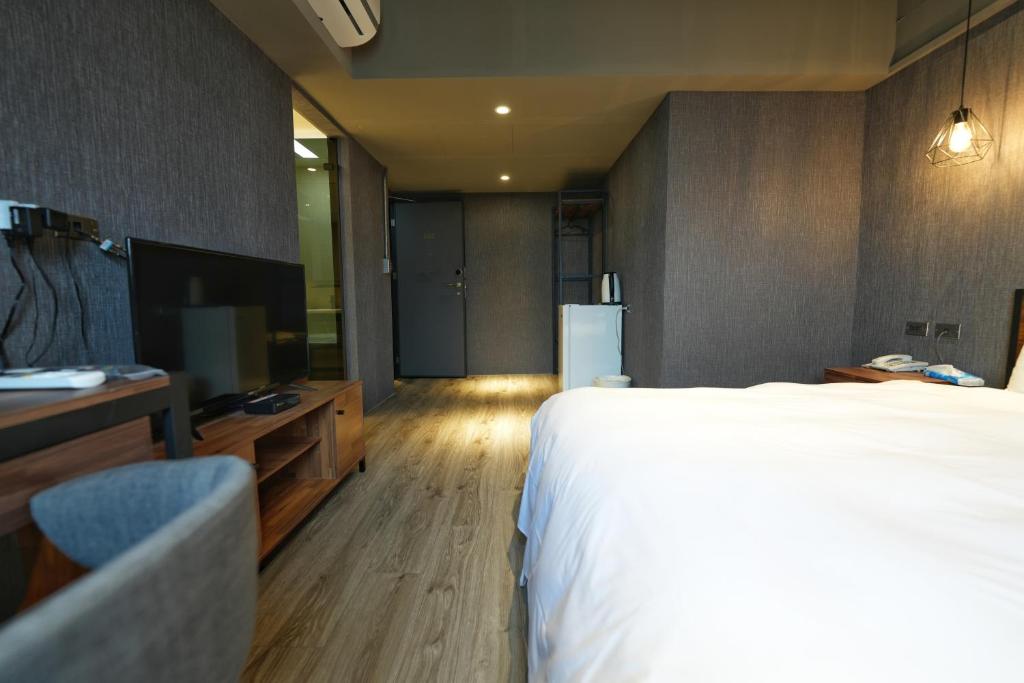 Postel nebo postele na pokoji v ubytování Meworld Hotel - Songshan