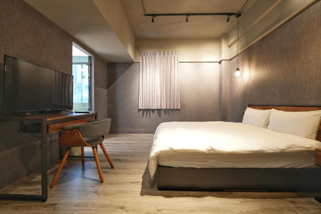 Postel nebo postele na pokoji v ubytování Meworld Hotel - Songshan