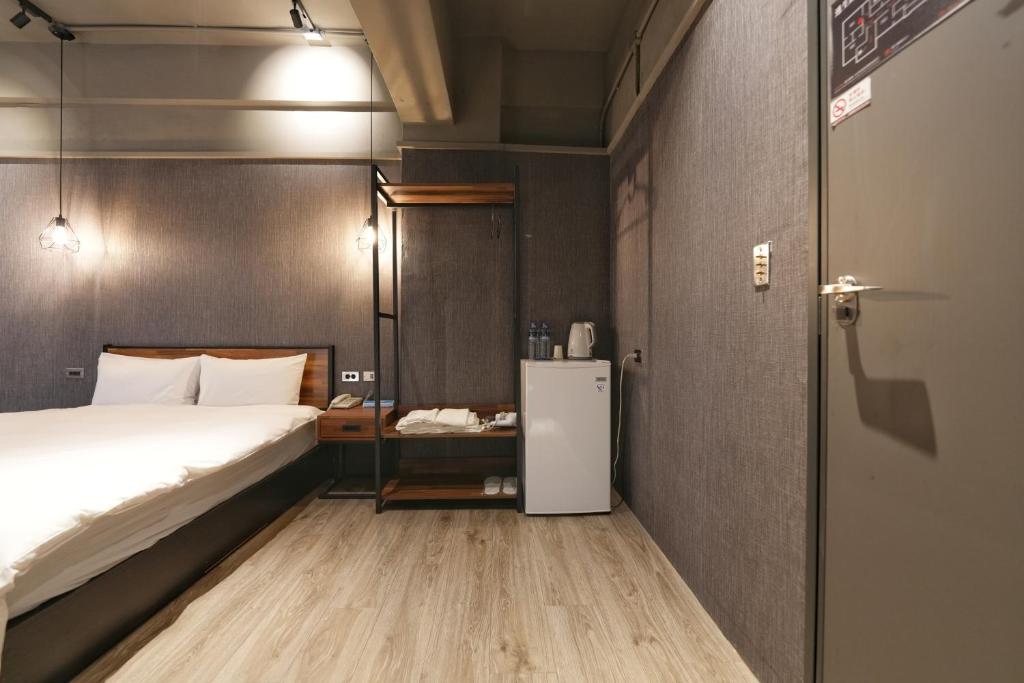 Postel nebo postele na pokoji v ubytování Meworld Hotel - Songshan