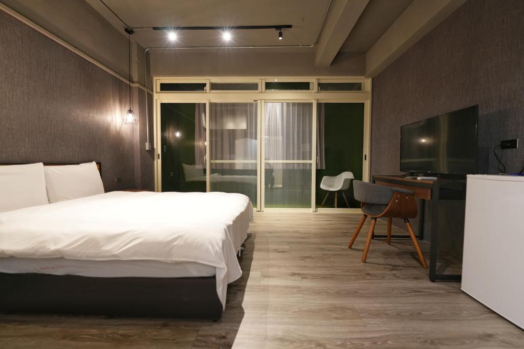 Postel nebo postele na pokoji v ubytování Meworld Hotel - Songshan